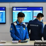 Home 22 몽골 이민 절차 - A detailed scene of a modern Mongolian immigration checkpoint at Ulaanbaatar’s Chinggis Khaan Intern...